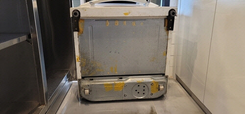 현금 뭉치가 붙어있던 김치냉장고 외부 바닥. <제주서부경찰서 제공>